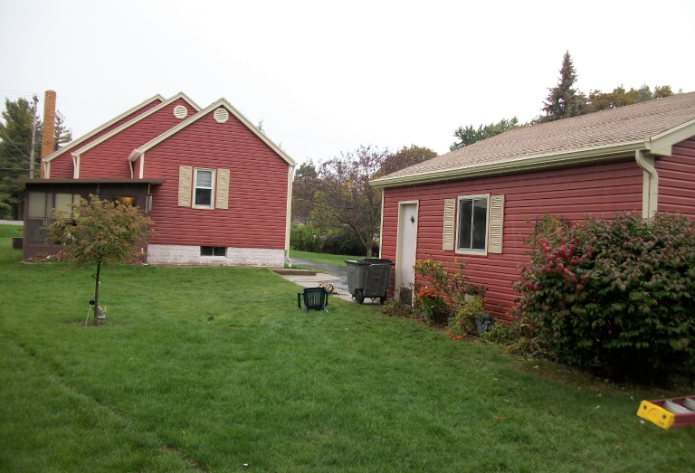 After- Custom red siding and tan trim